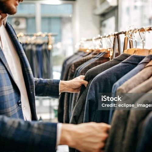 Businessman trying suit in store